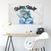 Shark Squad flag hung above a desk showing cartoon shark splash design