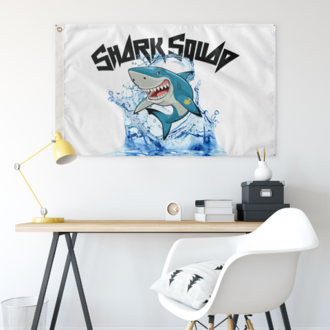 Shark Squad flag hung above a desk showing cartoon shark splash design