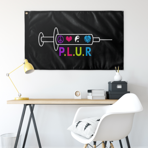 Black syringe rave flag above desk showing peace heart yinyang handshake icons with P.L.U.R text