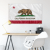 California Rave Fam flag hung on wall above desk with lamp and chair