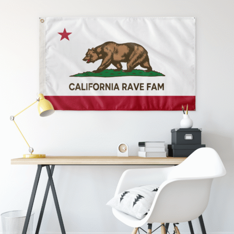 California Rave Fam flag hung on wall above desk with lamp and chair