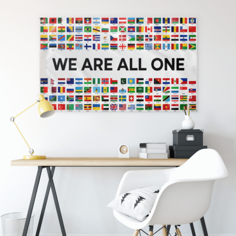 world flags grid rave flag with WE ARE ALL ONE text hanging above desk setup