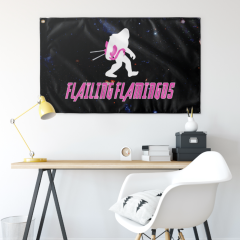 Galaxy rave flag with bigfoot and pink flamingo design hung above a desk setup