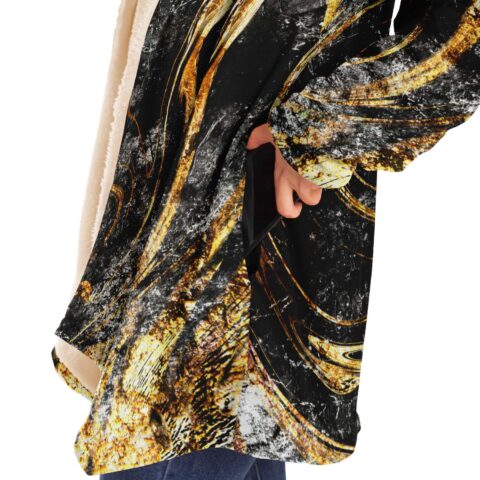 Close-up of cloak side pocket showing black gold marbled texture and sherpa lining