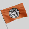 Orange circular kanji flag waving on a pole, close-up angled view