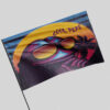 Close-up of purple retro 80s rave flag waving on a pole highlighting the sunglasses