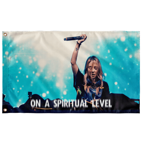 Teal rave flag showing DJ raising microphone with On A Spiritual Level text