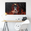 Black X logo flame rave flag hung on white wall above minimalist desk setup