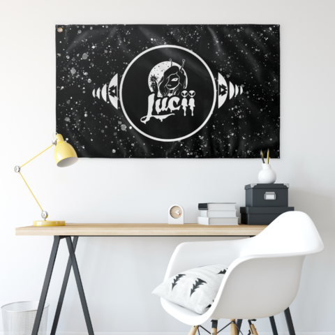 Lucii badge rave flag above desk showing alien and cosmic girl design against starfield