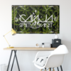 Dark green cannabis leaf flag hanging above a desk with yellow lamp and white chair