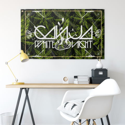 Dark green cannabis leaf flag hanging above a desk with yellow lamp and white chair