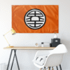 Orange circular kanji flag hung above a desk in a minimalist room setting