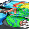 Close-up of folded rave flag fabric highlighting green swirl pattern and bold white festival text