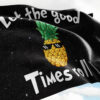 Flag waving outdoors showing cartoon pineapple design with pixel sunglasses on starry background