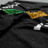 Close-up of grommet corner and pineapple graphic on black starry festival flag fabric