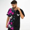 close-up side pose of man in pink floral split jersey with wing logo