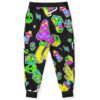 Back view of black joggers showing cartoon sticker pattern with neon mushroom alien face