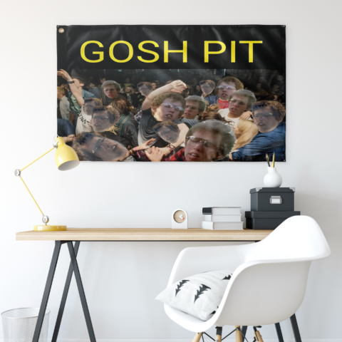 Gosh Pit rave flag hung above desk with yellow lamp and white chair