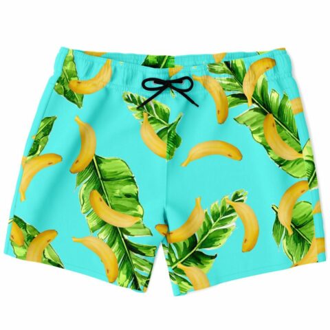 Banana leaf print swim shorts laid flat on turquoise background with black drawstring bow