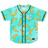 Turquoise cartoon banana print baseball jersey with BC chest patch flat lay front view