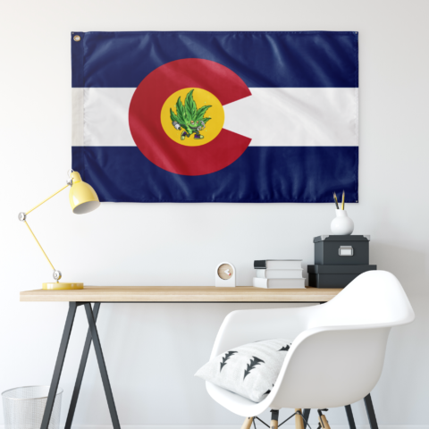 Colorado state rave flag with cannabis leaf mascot hung above a desk as wall decor