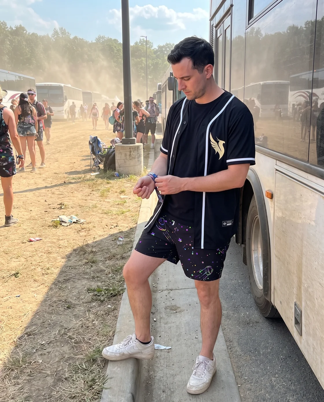 Man wearing a black baseball jersey open over a tee with shorts at a festival