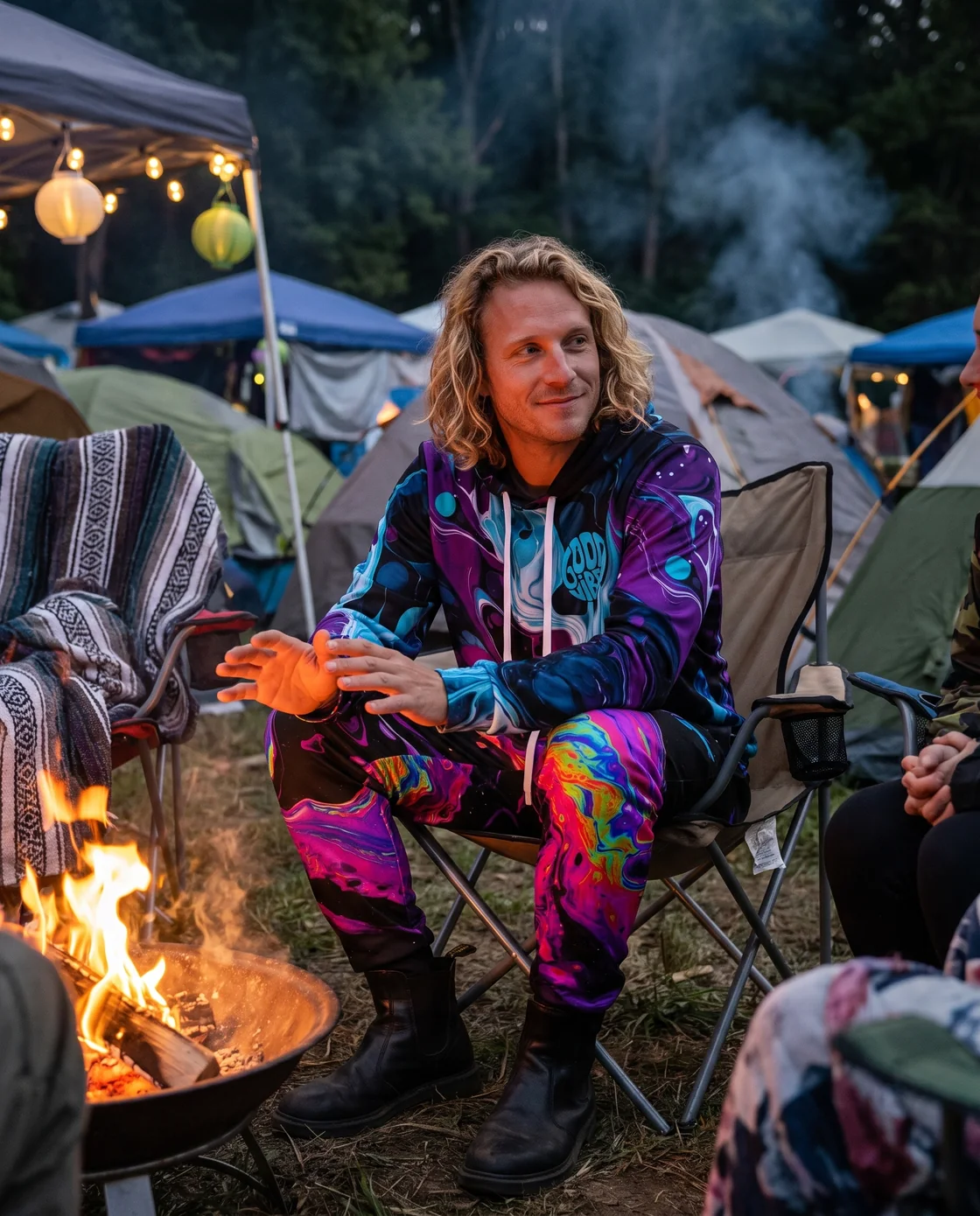 Man wearing a purple printed hoodie with joggers on a cold festival night