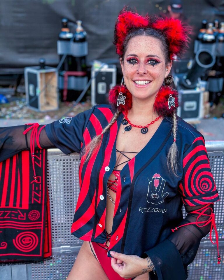 A woman in a red and black outfit posing for a photo.