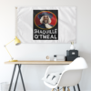 White portrait parody rave flag hanging on wall above a desk with yellow lamp
