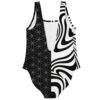 Black white split rave swimsuit back flat lay showing mirrored swirl and geometric pattern