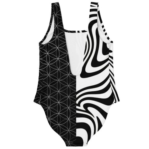 Black white split rave swimsuit back flat lay showing mirrored swirl and geometric pattern