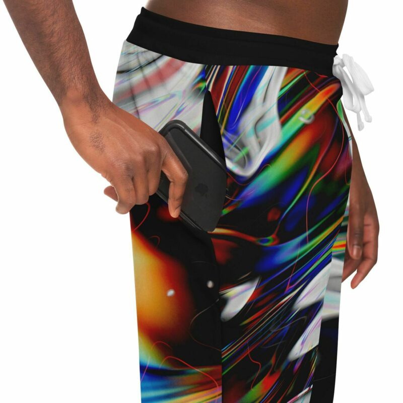 A man holding a Glitch Jogger while wearing a colorful shorts.