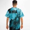 Model showing back of teal liquid marble jersey with bold black MIA lettering