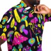 Close-up of the vibrant mushroom design on the rave button-down shirt worn by a model