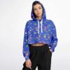 Model wearing cropped hoodie with playful dinosaur print and drawstrings