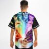Man modeling black baseball jersey with rainbow-colored creature evolution artwork across the back