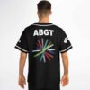 Model wearing black rave baseball jersey with text and design on the back, model back view