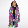 Bright candy print cloak worn open, revealing a black-lined hood and colorful front panels