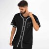 Angled front view of black jersey with chainsaw figure artwork and cartoon sleeve line drawings