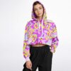 Model wearing colorful cropped hoodie with graphics, front view