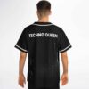 Black-and-white halftone wave jersey back with “TECHNO QUEEN” text, worn by a model indoors