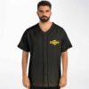 Yellow gear emblem on dark charcoal front with button trim against white studio backdrop