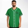 Front view of green jersey with frog holding a flower, white piping, and leafy trim
