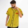 Mustard yellow vintage-washed rose graphic jersey shows black piping and red sleeve lettering, angled view