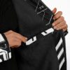 Black fleece interior of a cyber circuit cloak shown close-up, with patterned outer panels