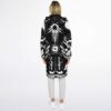 Model wearing a futuristic circuit-board cloak, back view showing the central mechanical emblem