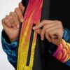 Close-up of black front zipper, yellow-pink sunburst trim, and plush fleece lining