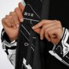 Close-up of geometric cyber pattern cloak zipper and black fleece lining, hands opening front