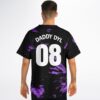Model wearing the back of a purple marbled swirl jersey with “DADDY DYL” and 08