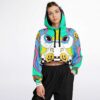 Model wearing the trippy rave cropped hoodie in teal and yellow with lively all-over patterns